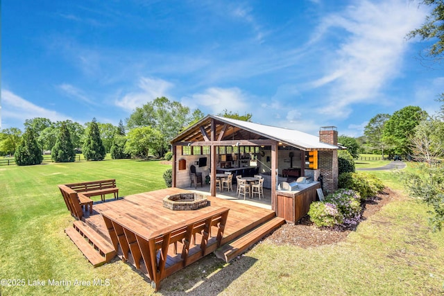 view of patio with a fire pit and a wooden deck