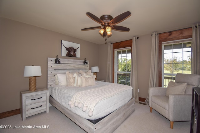 bedroom featuring access to exterior, baseboards, and light carpet