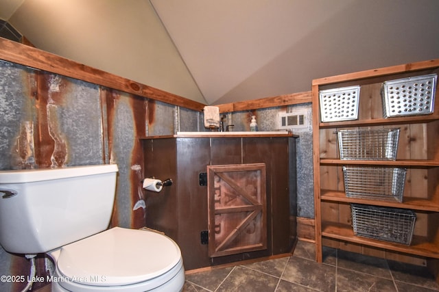 bathroom featuring toilet, visible vents, tile patterned flooring, and lofted ceiling