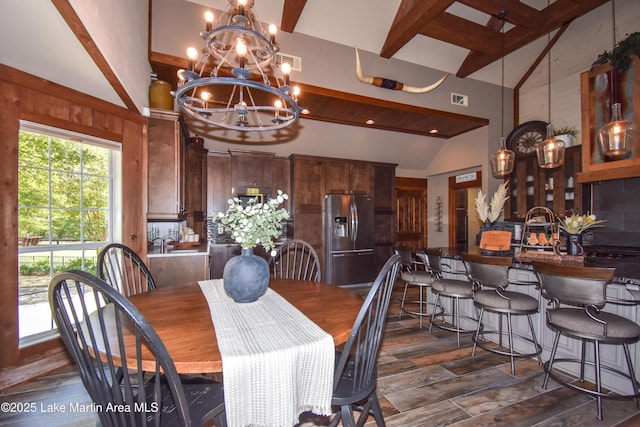 dining space with visible vents, vaulted ceiling with beams, an inviting chandelier, and dark wood-style floors
