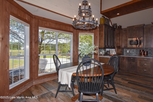 dining space with a chandelier, plenty of natural light, and dark wood-style floors