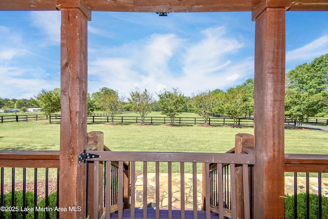 view of yard featuring fence and a rural view