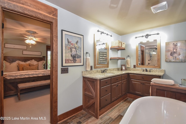 bathroom featuring a soaking tub, connected bathroom, visible vents, wood finished floors, and a sink