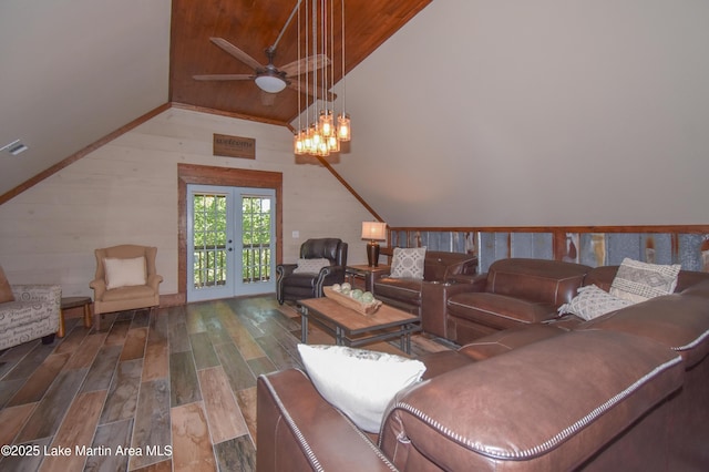 living area with ceiling fan with notable chandelier, vaulted ceiling, wood ceiling, wood finished floors, and french doors