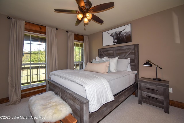 bedroom featuring carpet floors, access to exterior, a ceiling fan, and baseboards