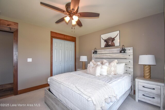 bedroom with light carpet, baseboards, a closet, and a ceiling fan