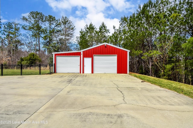 detached garage featuring fence