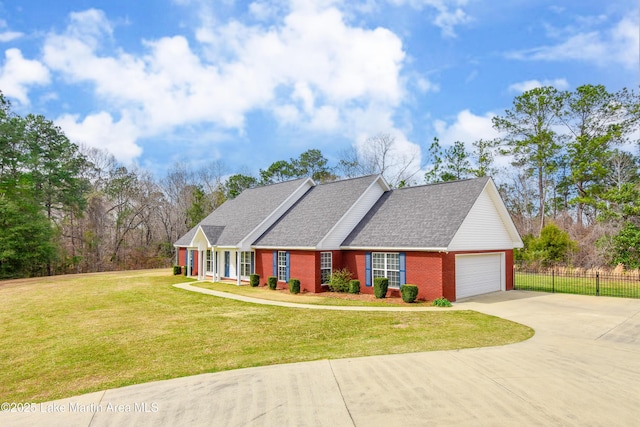 view of front of house with a garage, driveway, fence, a front yard, and brick siding