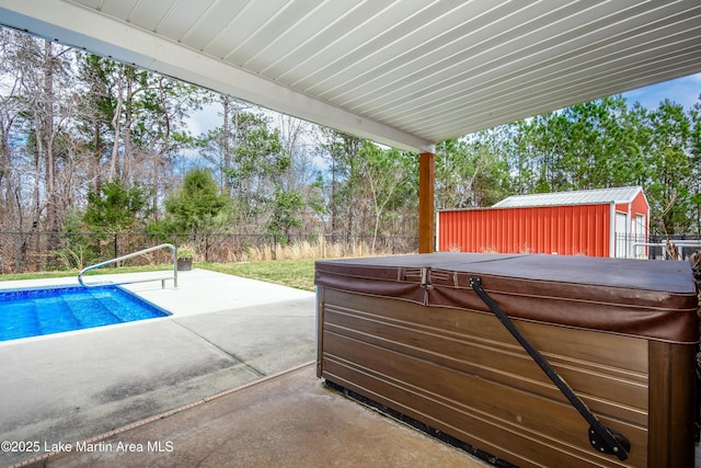 view of patio / terrace featuring a fenced in pool, a fenced backyard, an outdoor structure, and a hot tub