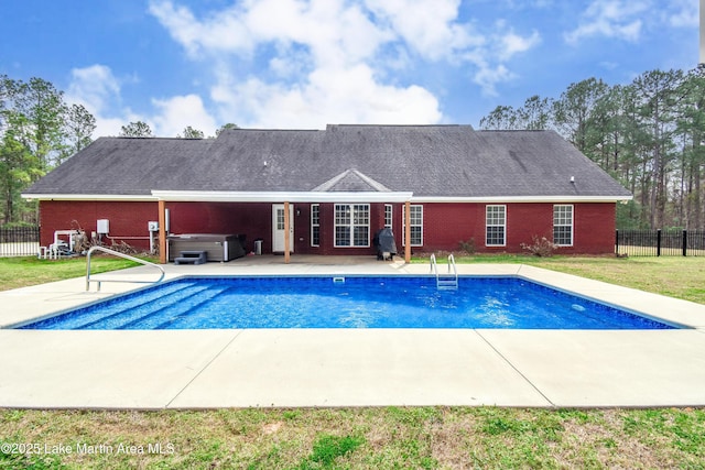 view of swimming pool with a hot tub, a patio, grilling area, fence, and a yard