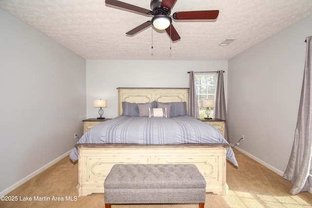 bedroom featuring a textured ceiling, light colored carpet, visible vents, and baseboards