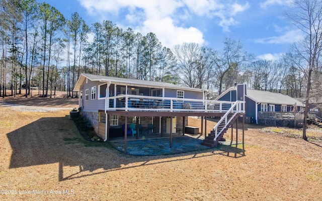 32 Dennis Creek Cir, Jacksons Gap, AL 36861 - rear view of house featuring a deck, stairs, a patio, and a sunroom