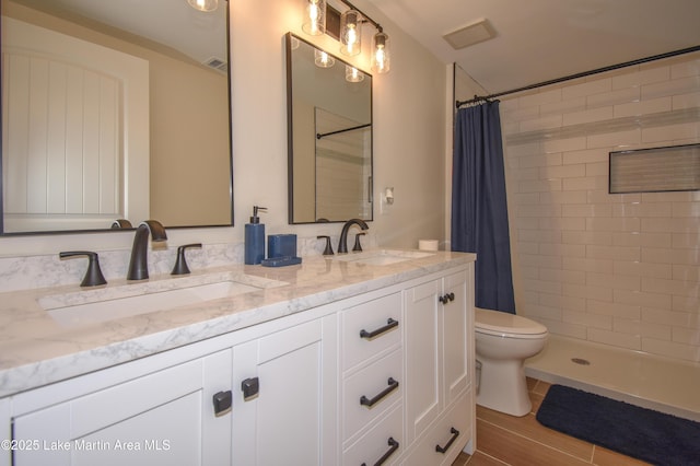 bathroom featuring vanity, a shower with curtain, and toilet