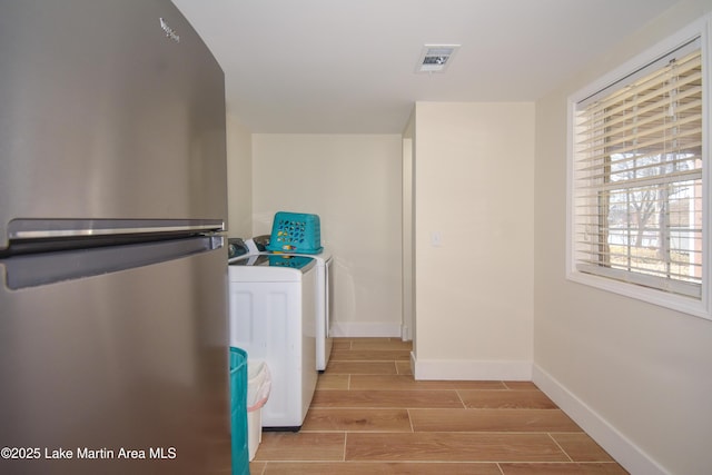 32 Dennis Creek Cir, Jacksons Gap, AL 36861 - laundry room with washer and clothes dryer and wood finish floors