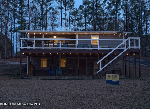 back house at dusk with a deck