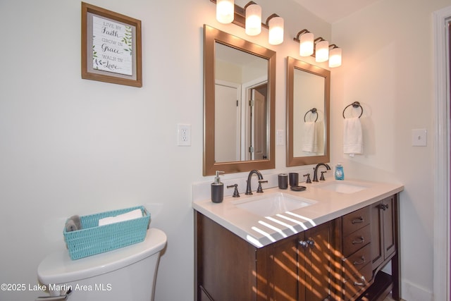bathroom featuring toilet and vanity