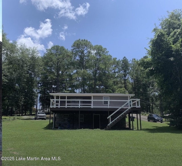 32 Dennis Creek Cir, Jacksons Gap, AL 36861 - rear view of property featuring a wooden deck, a lawn, and stairs