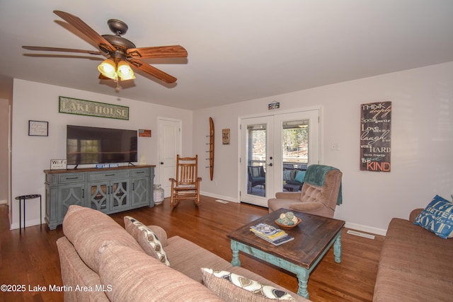 living room with ceiling fan, french doors, and dark hardwood / wood-style flooring