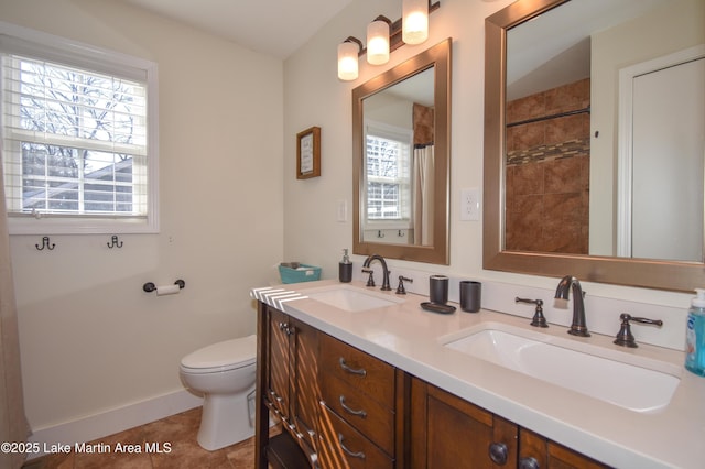 bathroom with tile patterned floors, vanity, curtained shower, and toilet