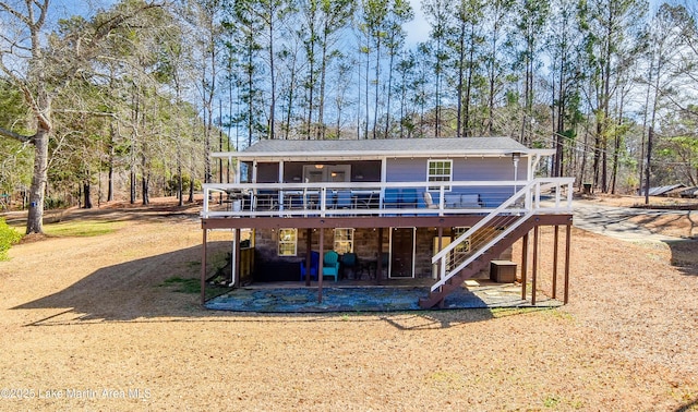 32 Dennis Creek Cir, Jacksons Gap, AL 36861 - back of property featuring a deck, a patio, stairway, roof with shingles, and a sunroom
