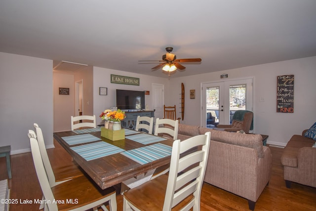 dining space with french doors, ceiling fan, and wood-type flooring