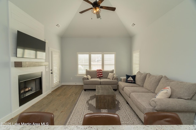 153 Whisper Trce, Tallassee, AL 36078 - living area featuring ceiling fan, light wood-style flooring, a large fireplace, and high vaulted ceiling