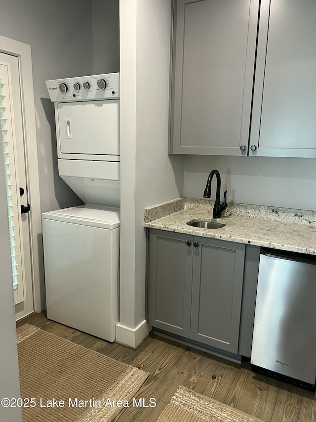 153 Whisper Trce, Tallassee, AL 36078 - laundry room with stacked washing machine and dryer and dark wood-style flooring