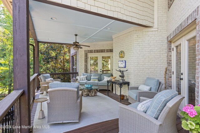 wooden deck with french doors, ceiling fan, and outdoor lounge area