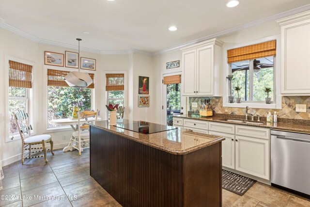 kitchen featuring sink, stone counters, backsplash, black electric cooktop, and stainless steel dishwasher