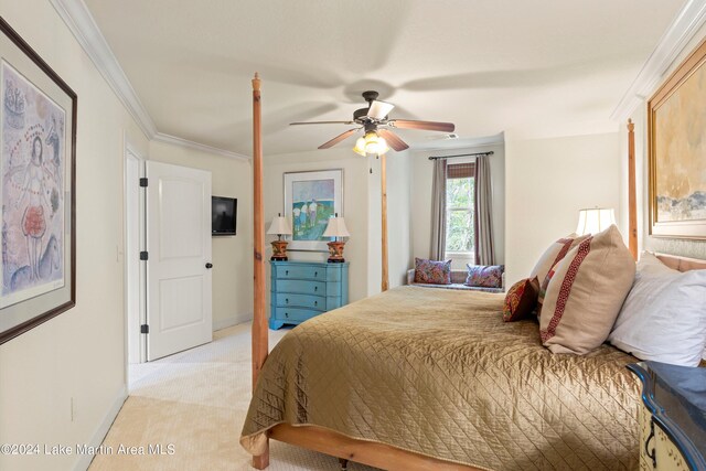 bedroom with ornamental molding, light colored carpet, and ceiling fan