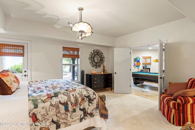 carpeted bedroom with multiple windows and billiards