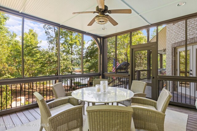 sunroom / solarium featuring ceiling fan