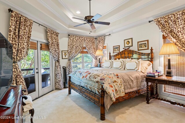 bedroom with crown molding, french doors, access to outside, light colored carpet, and a raised ceiling