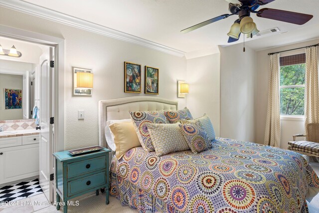 bedroom featuring ornamental molding, ceiling fan, and ensuite bathroom