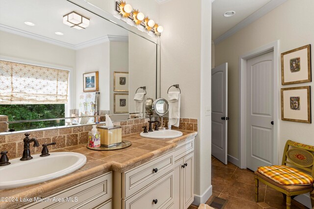 bathroom featuring tile patterned flooring, crown molding, tasteful backsplash, and vanity