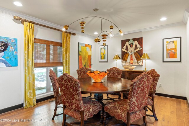 dining area featuring ornamental molding and light wood-type flooring