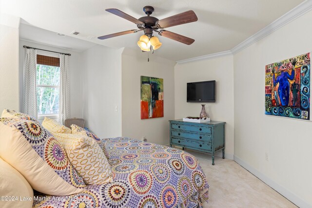 carpeted bedroom with crown molding and ceiling fan