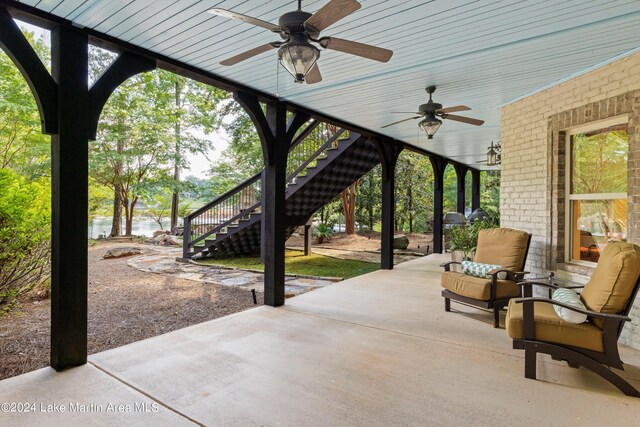 view of patio / terrace featuring a water view and ceiling fan