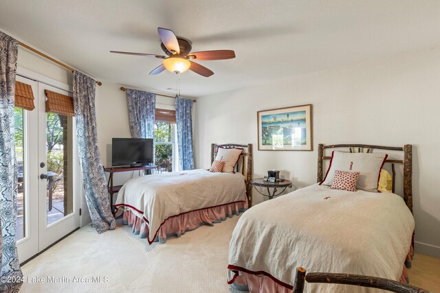 carpeted bedroom featuring french doors, ceiling fan, and access to exterior