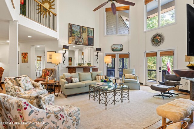 living room featuring a wealth of natural light, ceiling fan, and french doors