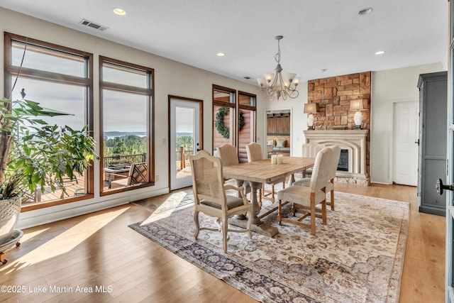 dining area with an inviting chandelier and light hardwood / wood-style floors