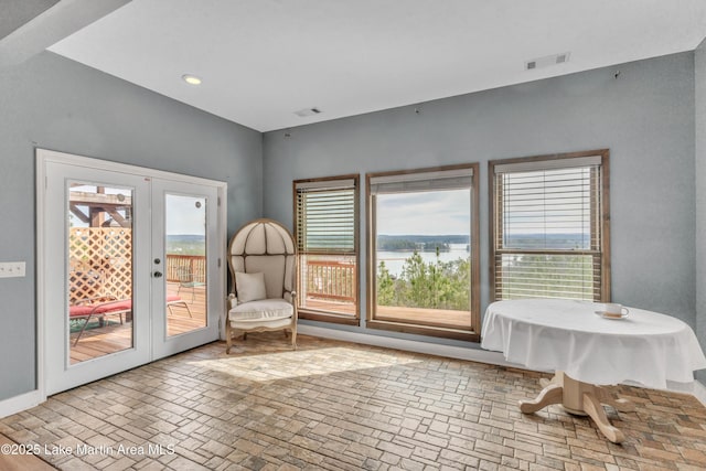 living area with a water view and french doors