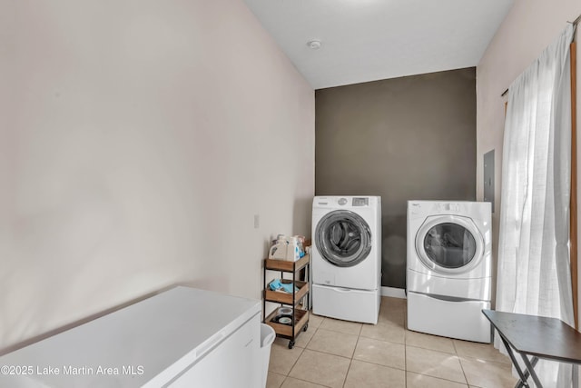 laundry room with independent washer and dryer and light tile patterned floors