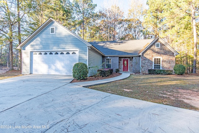 ranch-style home featuring a garage and a front yard