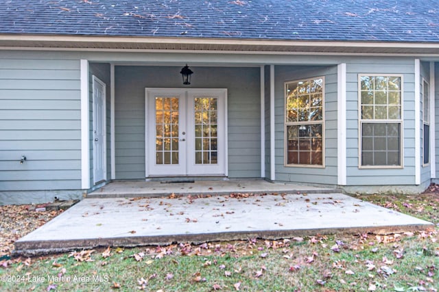 view of exterior entry with a patio area and french doors