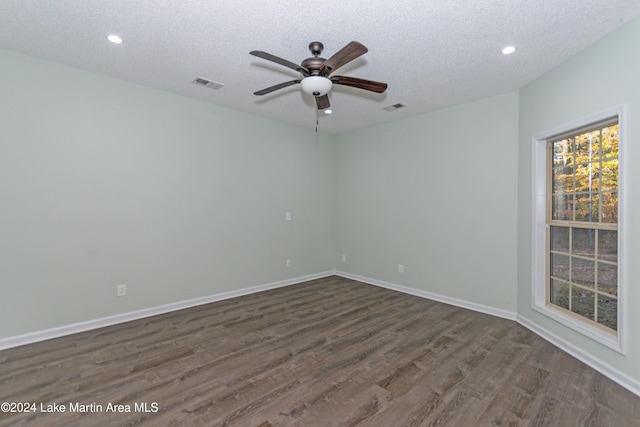 unfurnished room featuring a textured ceiling, ceiling fan, and dark wood-type flooring