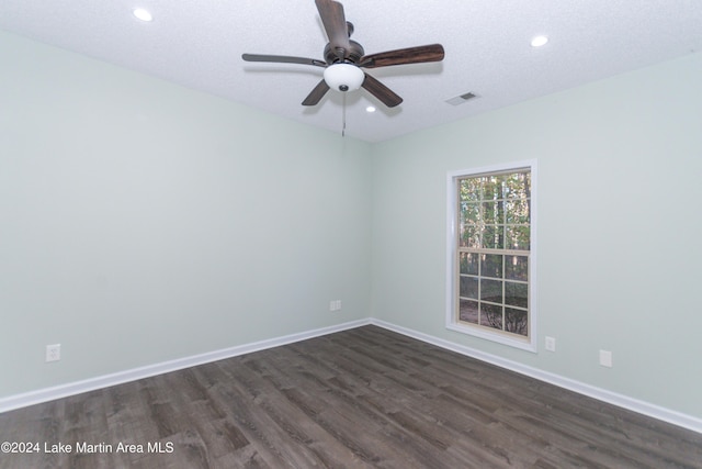 spare room featuring ceiling fan, dark hardwood / wood-style flooring, and a textured ceiling