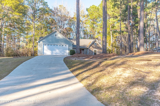 view of front of home with a front yard and a garage