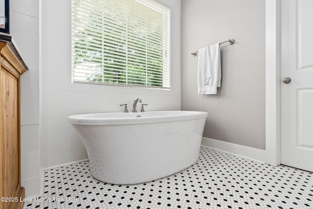 bathroom featuring tile patterned floors and a washtub