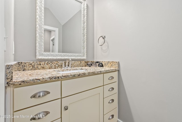 bathroom with vanity and vaulted ceiling